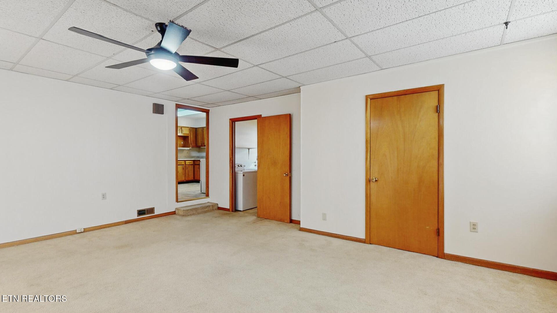 4004 Deerfield Road Knoxville, TN 37921 - Photo 14 of 34 an empty room with chandelier fan and windows