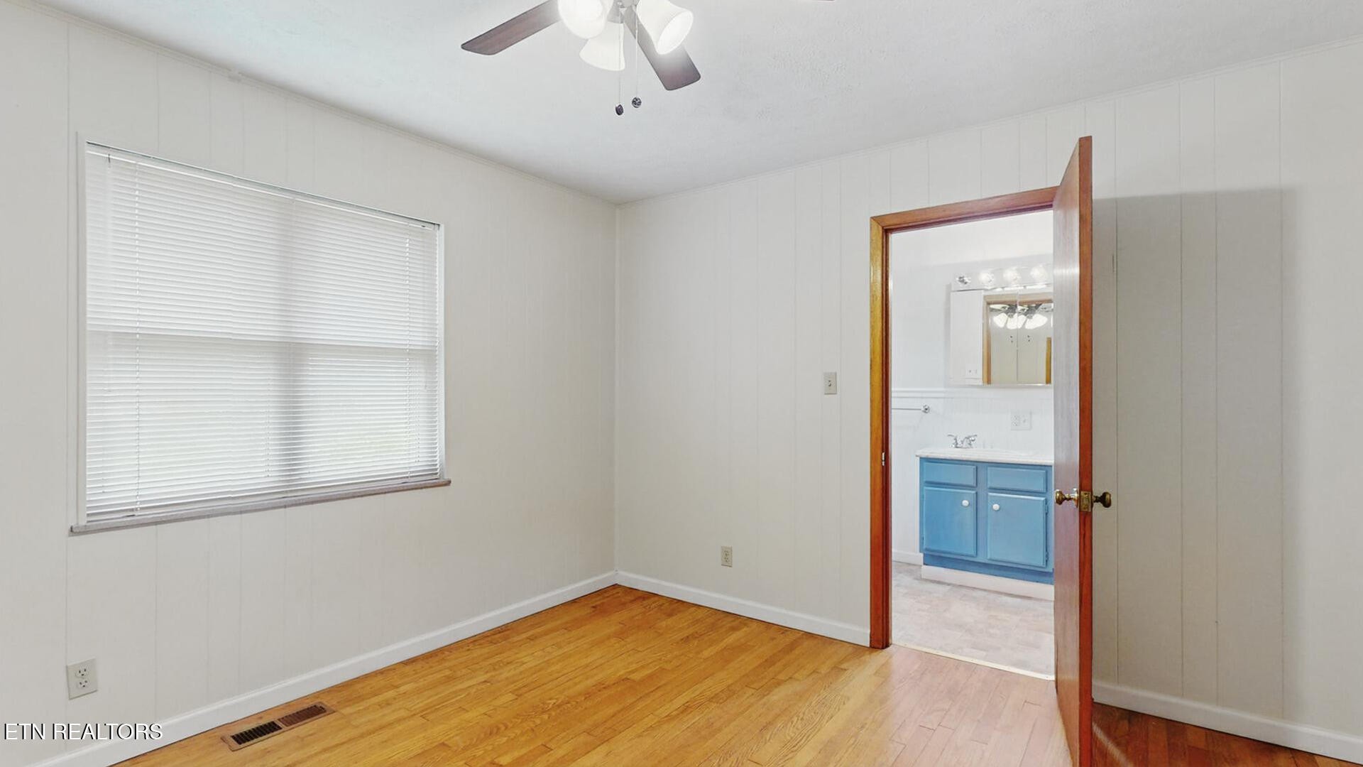 4004 Deerfield Road Knoxville, TN 37921 - Photo 16 of 34 an empty room with a window and wooden floor