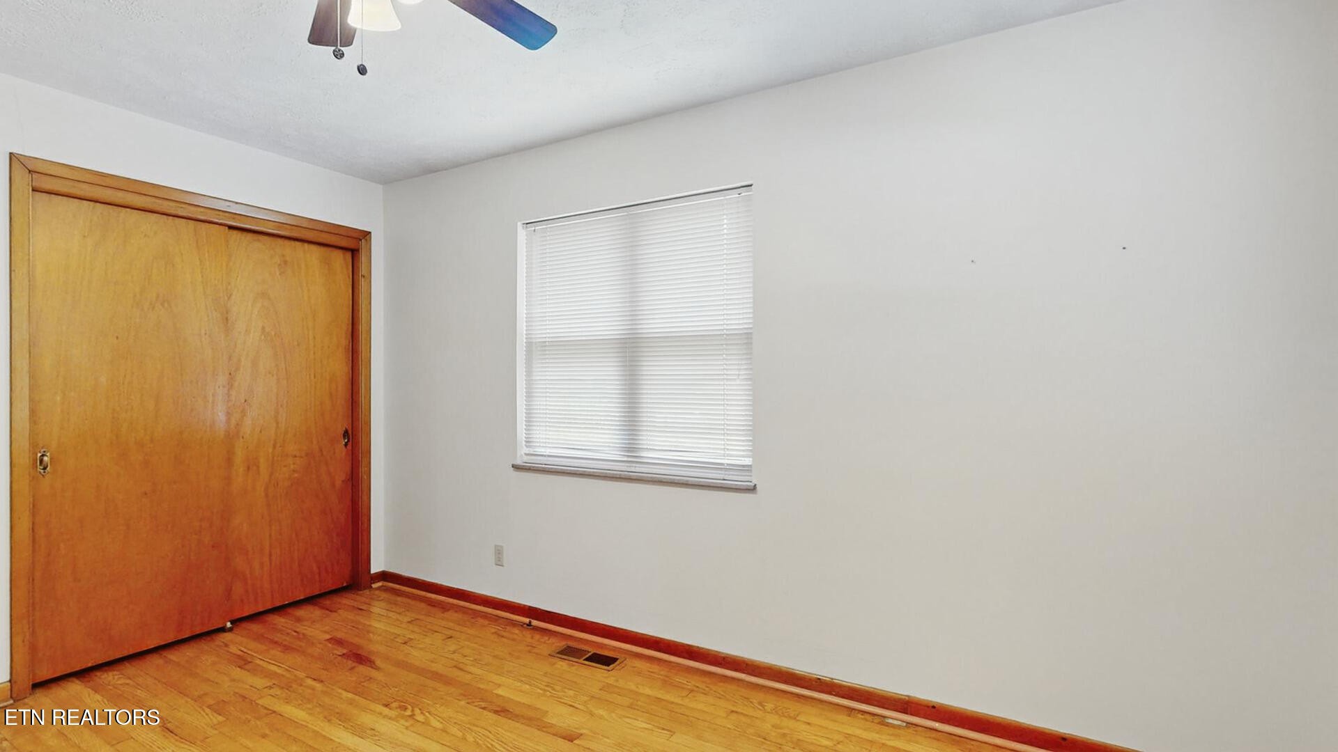 4004 Deerfield Road Knoxville, TN 37921 - Photo 26 of 34 a view of an empty room with wooden floor and a window
