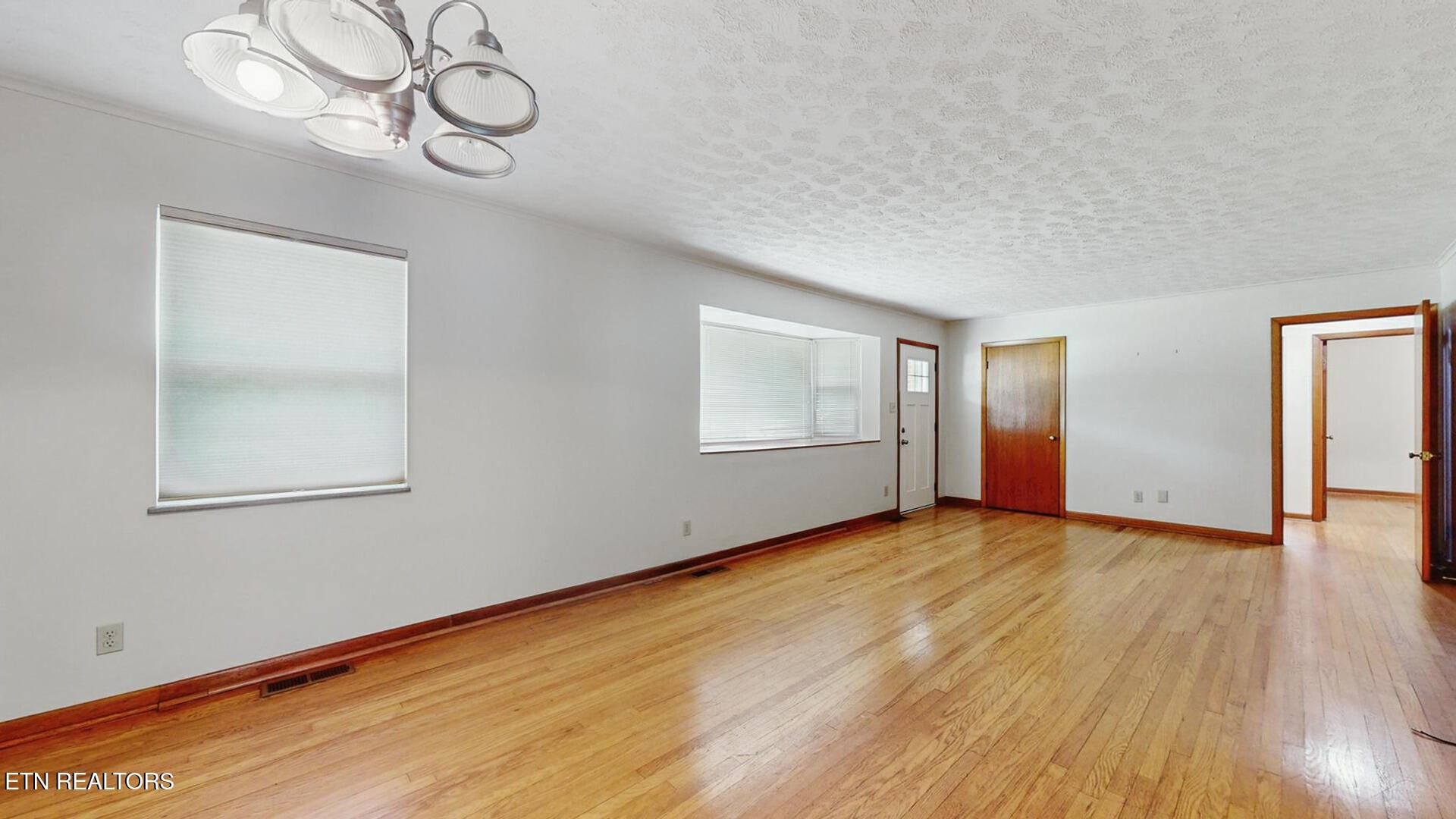 4004 Deerfield Road Knoxville, TN 37921 - Photo 6 of 34 a view of empty room with wooden floor and fan