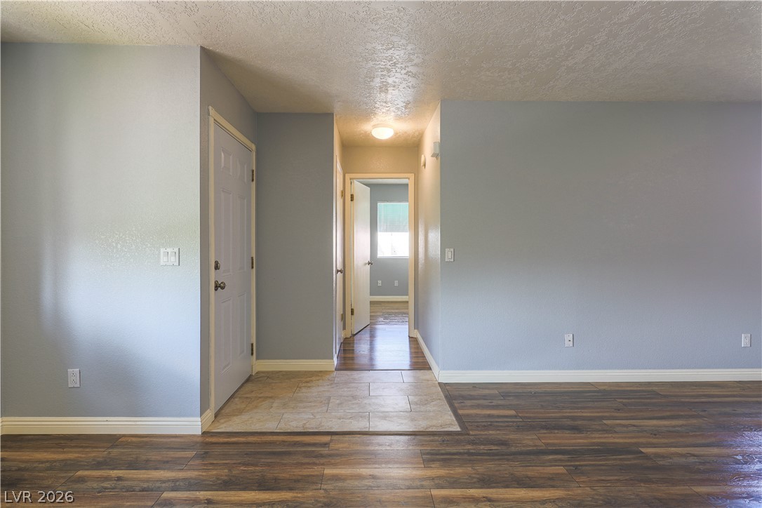 6750 Del Rey Avenue, Unit 267 Las Vegas, NV 89146 - Photo 3 of 20 A welcoming entryway transitions seamlessly from durable tile to attractive wood flooring, hinting at comfortable living.