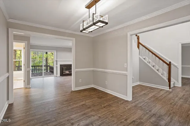 a living room with a fireplace and a floor to ceiling window