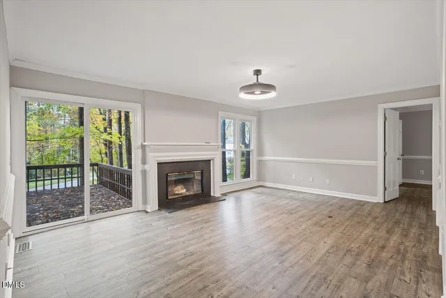 a living room with furniture fireplace and a large window