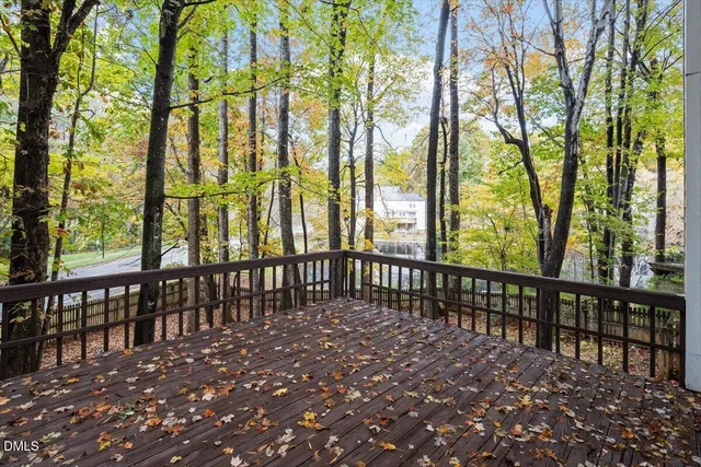 a view of staircase with wooden floor and white walls