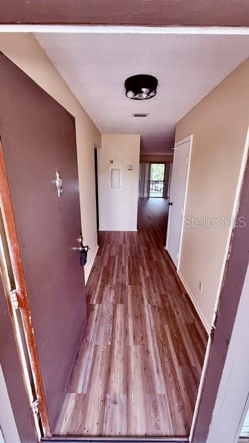 6519 West Newberry Road, Unit 206 Gainesville, FL 32605 - Photo 2 of 14 a view of a livingroom with wooden floor and staircase