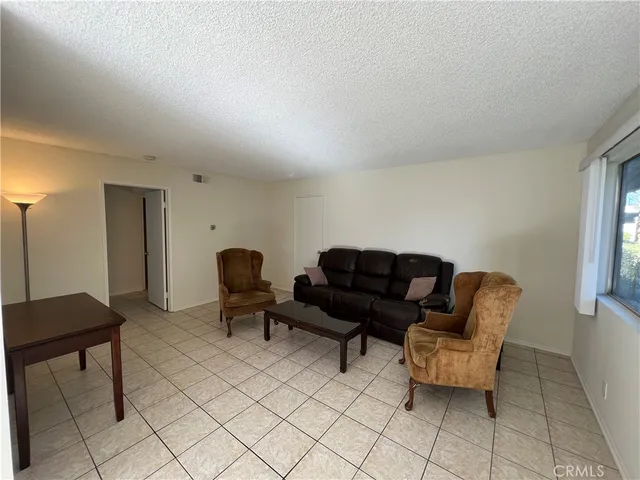 a living room with furniture and a chair