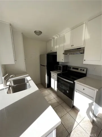 a kitchen with a sink cabinets and stainless steel appliances