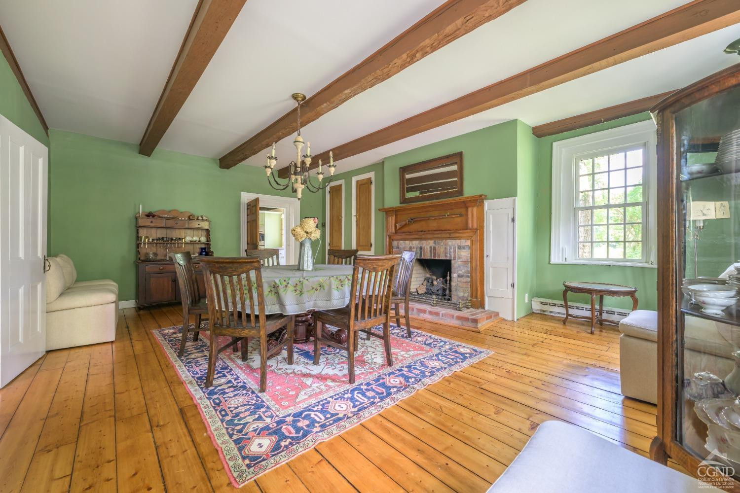 2221 Highway 9 Kinderhook, NY 12106 - Photo 12 of 41 a dining room with furniture a rug and wooden floor