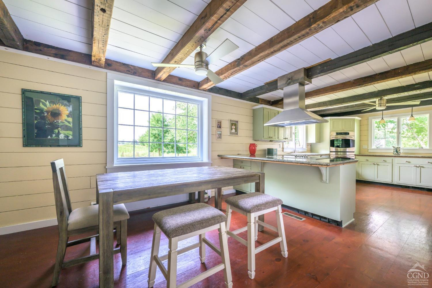 2221 Highway 9 Kinderhook, NY 12106 - Photo 13 of 41 a kitchen with a table chairs and wooden floor