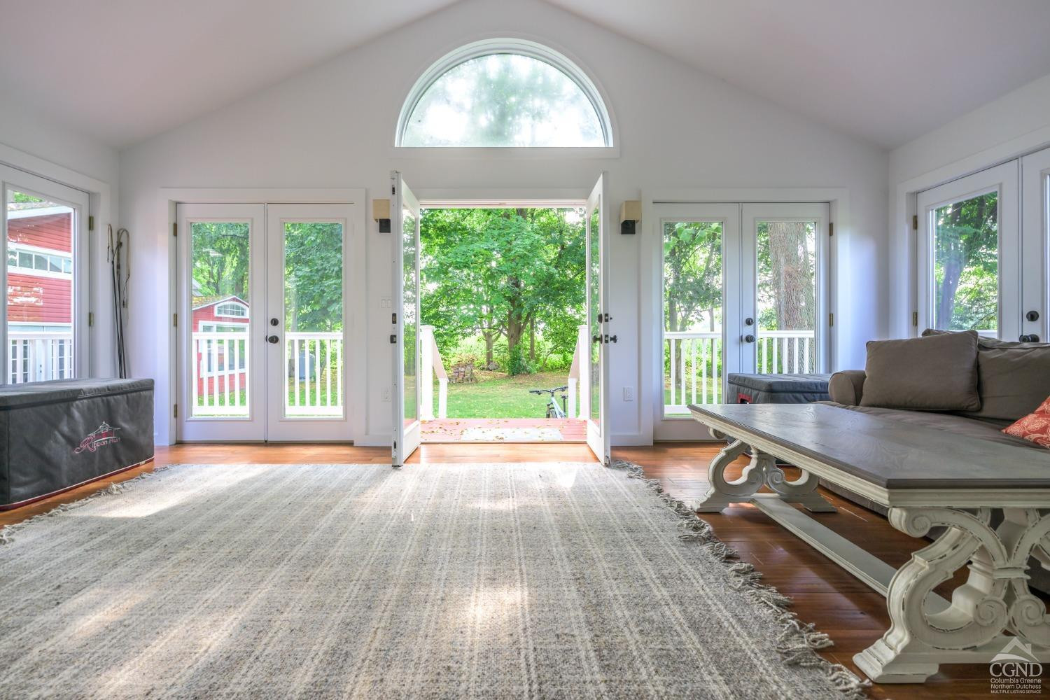 2221 Highway 9 Kinderhook, NY 12106 - Photo 25 of 41 a living room with a floor to ceiling window and wooden floor