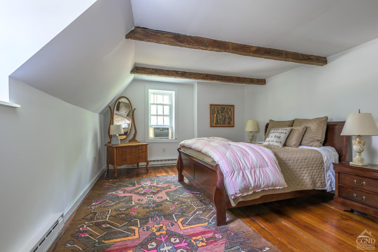 2221 Highway 9 Kinderhook, NY 12106 - Photo 27 of 41 a spacious bedroom with a bed and wooden floor