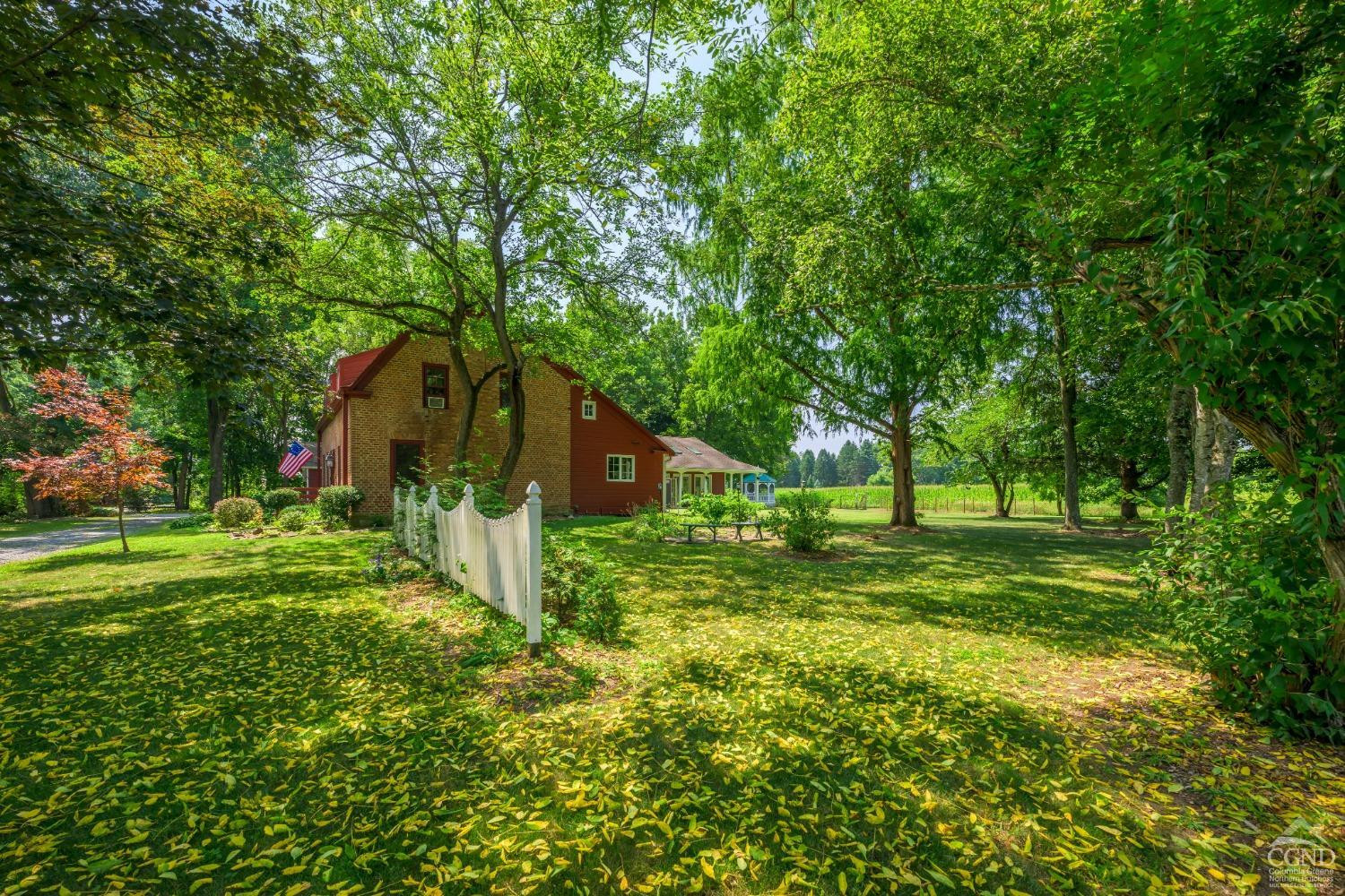 2221 Highway 9 Kinderhook, NY 12106 - Photo 39 of 41 a backyard of a house with plants and large tree