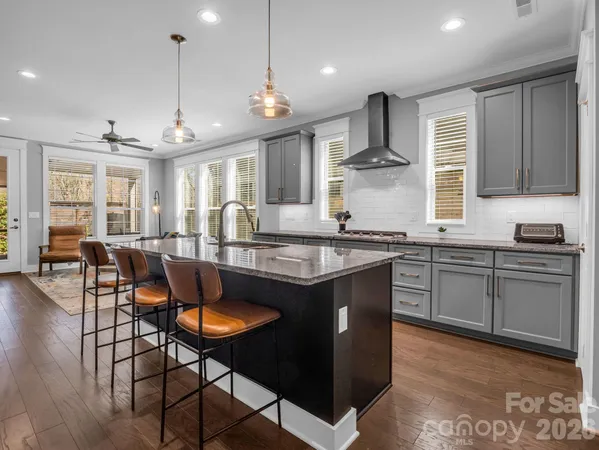 a kitchen with stainless steel appliances granite countertop stove top oven and cabinets