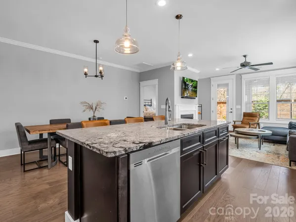 a large kitchen with a table and chairs