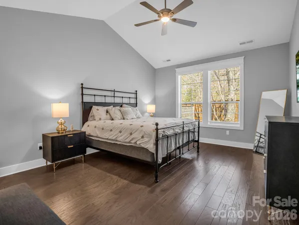 a bedroom with a bed and a painting on the wall