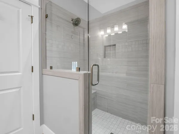 a kitchen with a stove and white cabinet