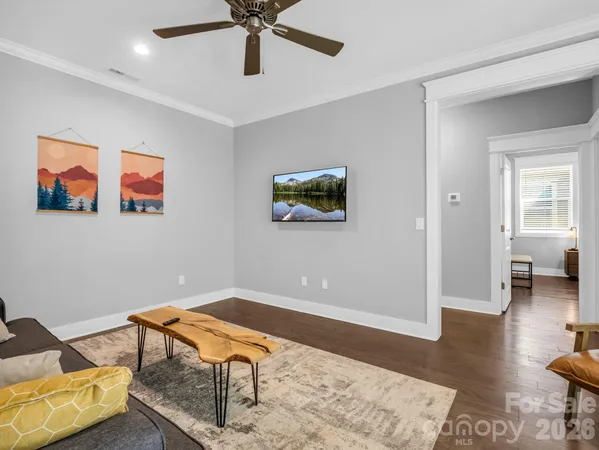 a view of a workspace with furniture and wooden floor