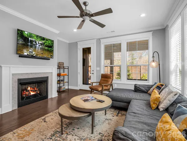 a living room with furniture a fireplace and a flat screen tv