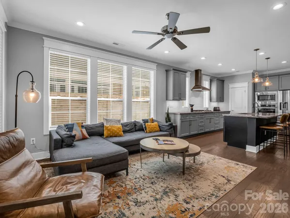 a kitchen with granite countertop a table chairs microwave and cabinets