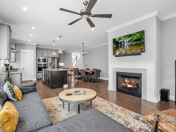a kitchen with granite countertop a stove a sink a dining table and chairs