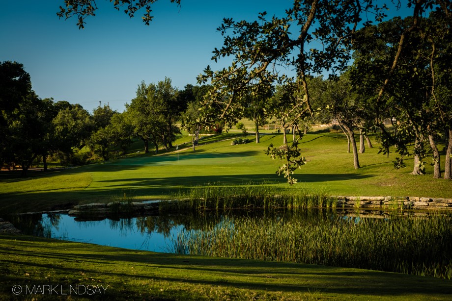 128 Hiram Cook Blanco, TX 78606 - Photo 36 of 40 An immaculate golf course beckons with a pristine putting green, tranquil pond, and verdant surroundings.