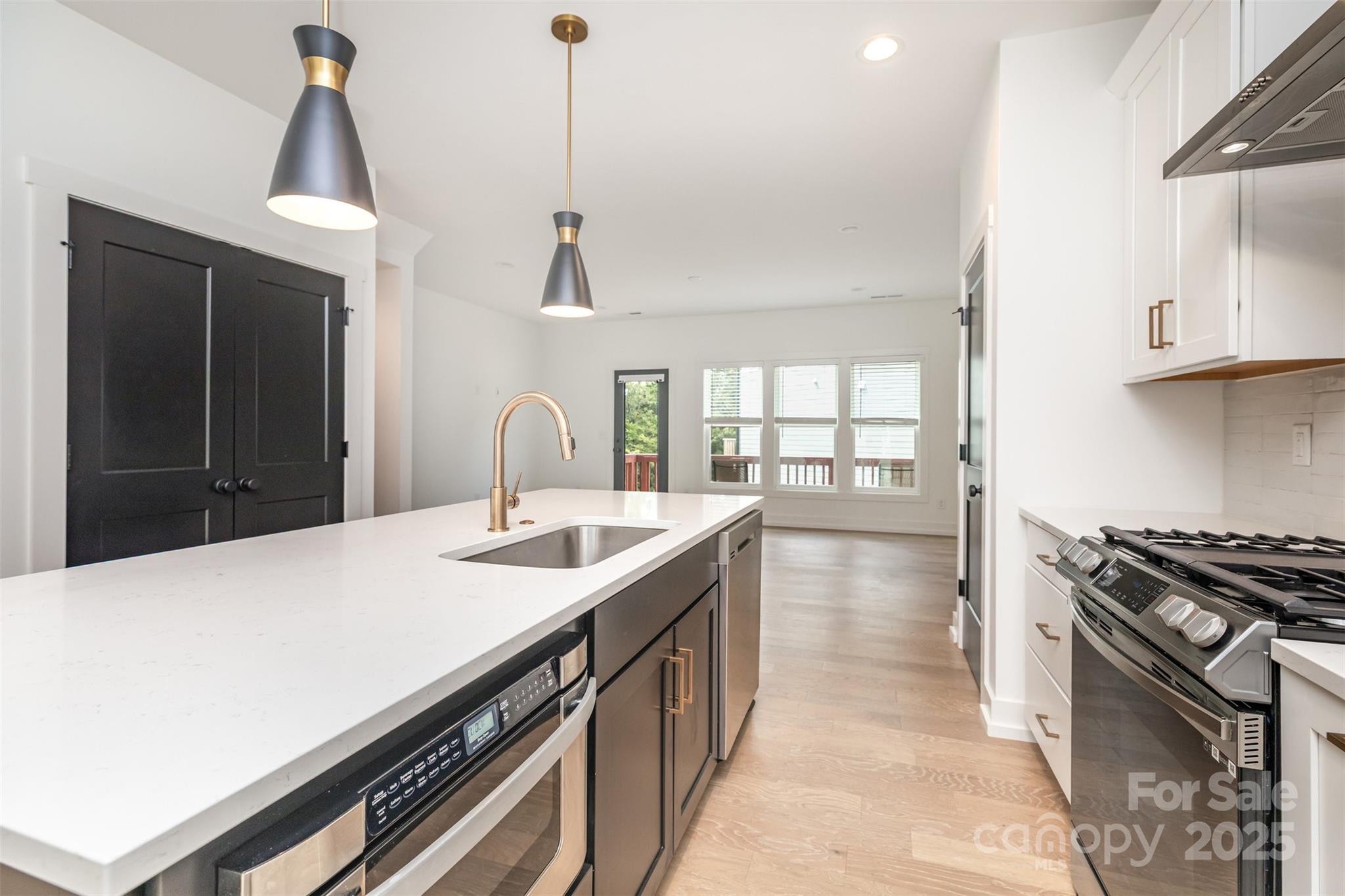 1500 Effingham Road Charlotte, NC 28208 - Photo 13 of 32 a kitchen with a stove and a sink