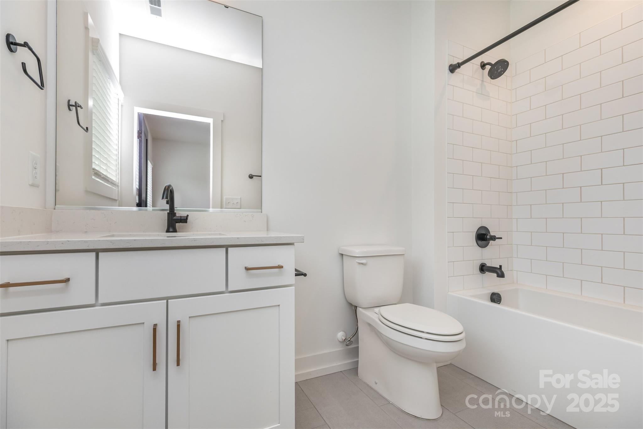 1500 Effingham Road Charlotte, NC 28208 - Photo 16 of 32 a bathroom with a toilet sink vanity tub and shower