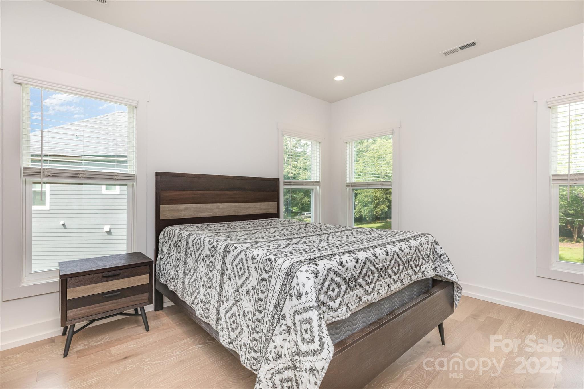 1500 Effingham Road Charlotte, NC 28208 - Photo 17 of 32 a bedroom with a bed wooden floor and window