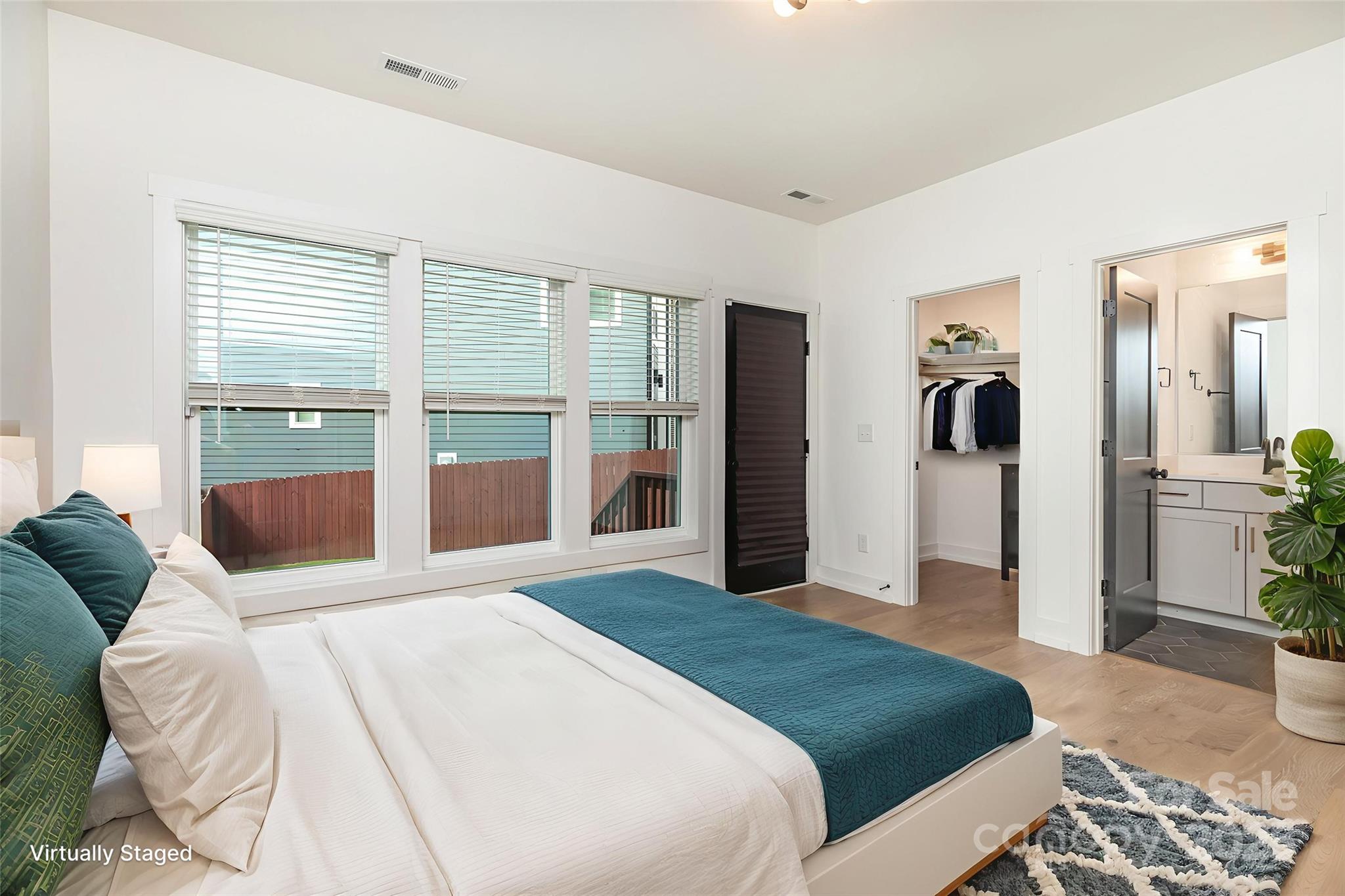 1500 Effingham Road Charlotte, NC 28208 - Photo 23 of 32 a bedroom with a large bed and a large window