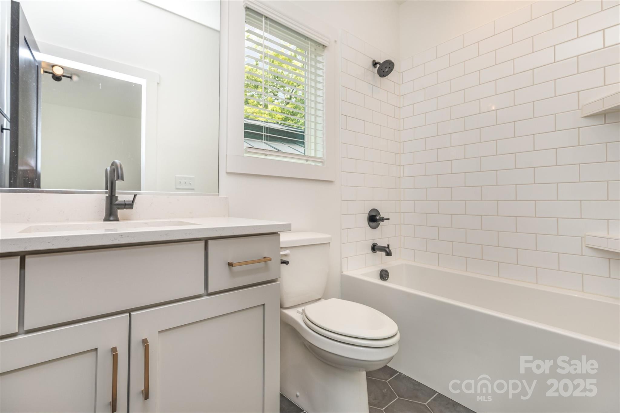 1500 Effingham Road Charlotte, NC 28208 - Photo 25 of 32 a bathroom with a sink a toilet and bathtub