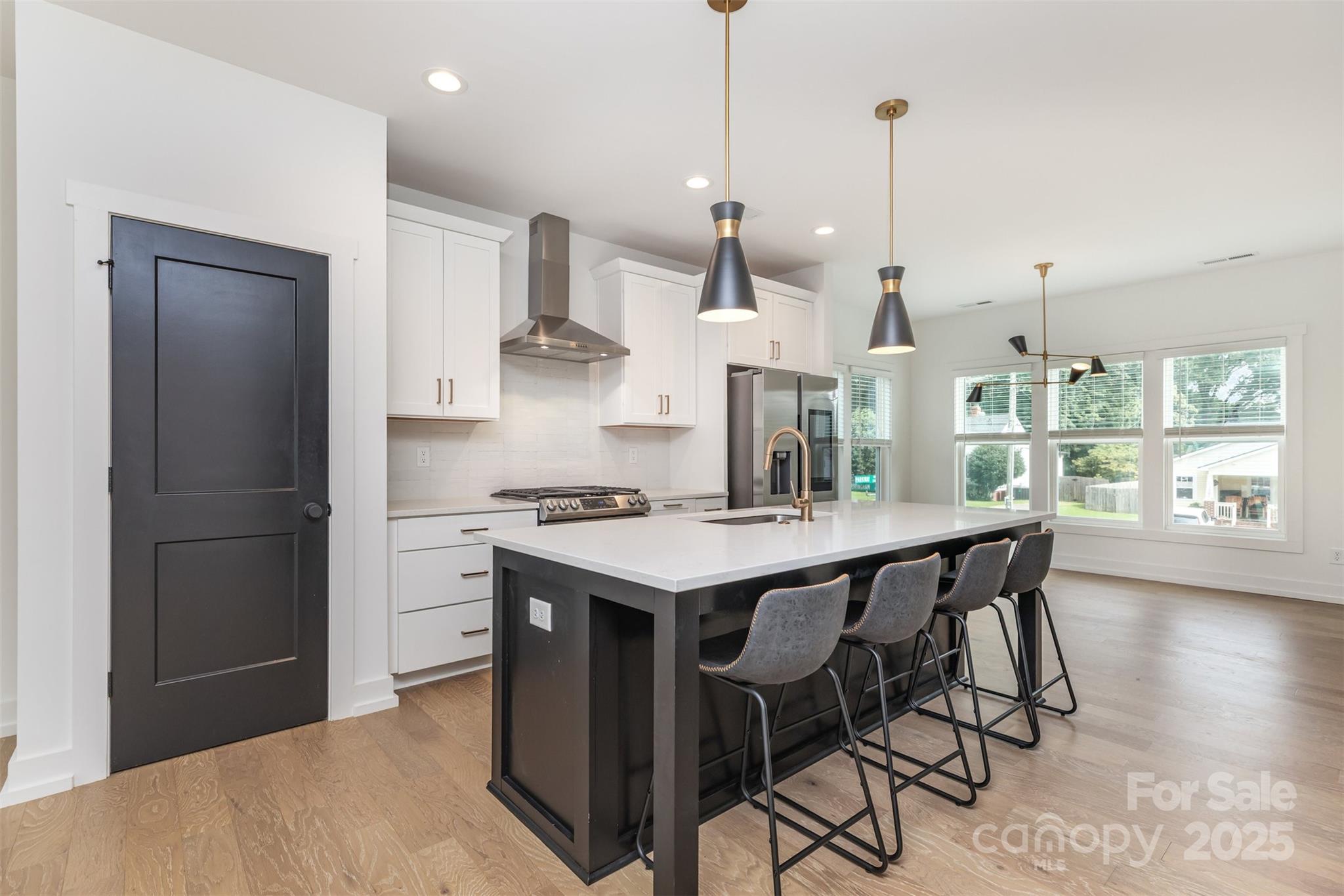 1500 Effingham Road Charlotte, NC 28208 - Photo 10 of 32 a kitchen with stainless steel appliances granite countertop a stove a refrigerator a oven a sink with a dining table and chairs