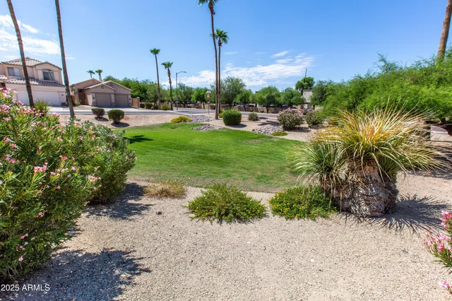 a view of a garden with a house