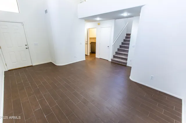 a view of a room with wooden floor and stairs