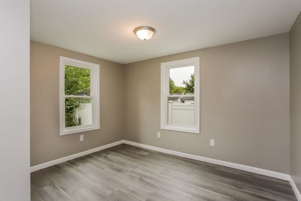 251 Edendale Street Springfield, MA 01104 - Photo 14 of 22 an empty room with wooden floor and windows