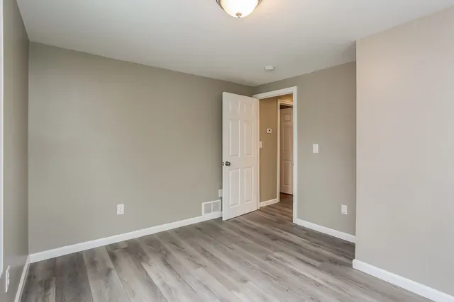 a view of an empty room and wooden floor