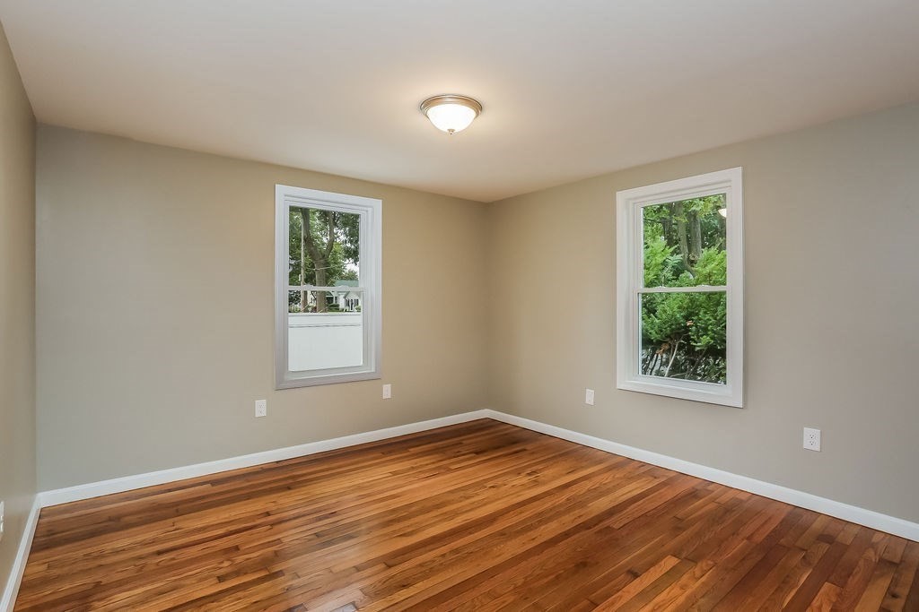 251 Edendale Street Springfield, MA 01104 - Photo 17 of 22 a view of an empty room with wooden floor and a window