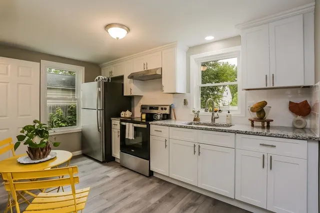 a kitchen with appliances cabinets and a window