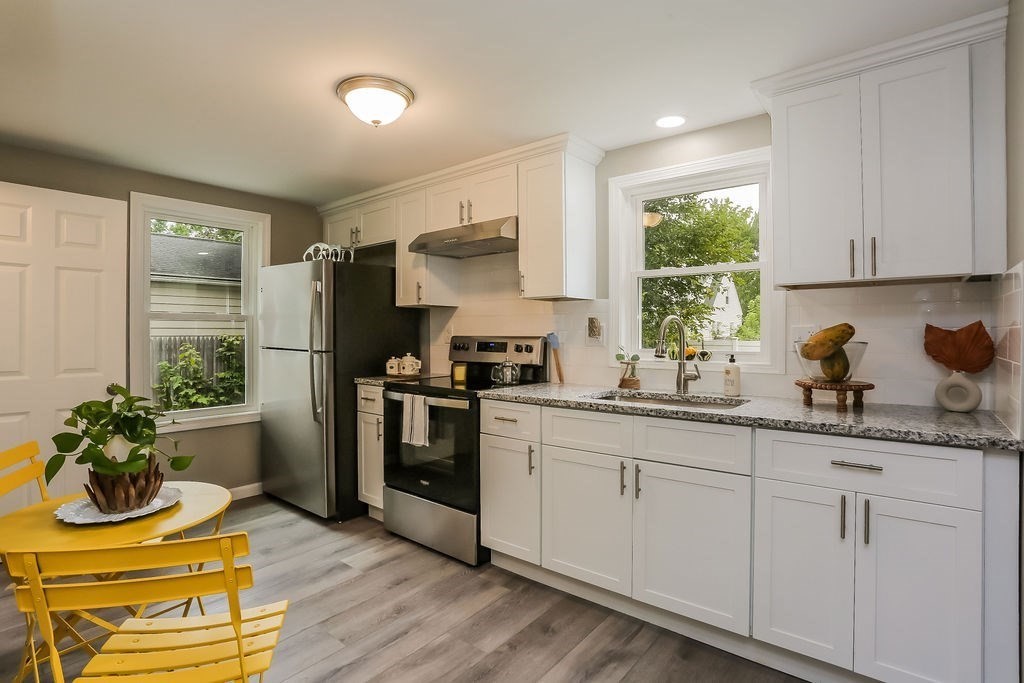 251 Edendale Street Springfield, MA 01104 - Photo 4 of 22 a kitchen with appliances cabinets and a window
