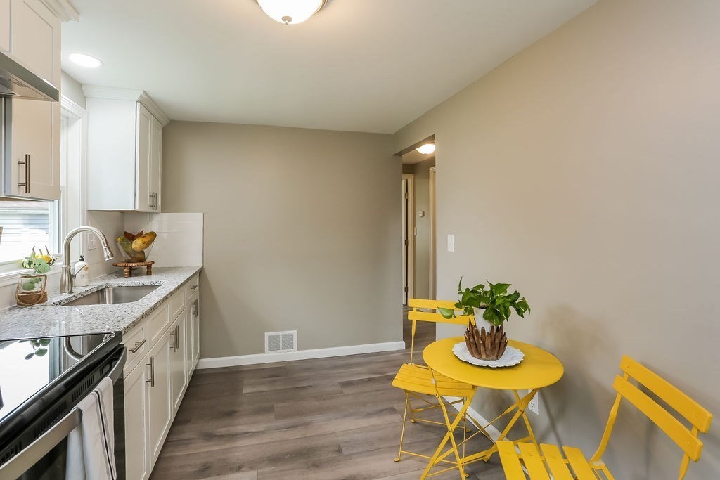 251 Edendale Street Springfield, MA 01104 - Photo 8 of 22 a kitchen with furniture and a potted plant