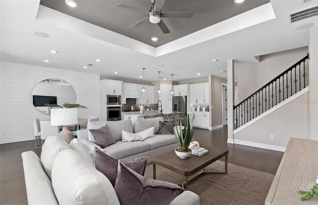 a living room with furniture kitchen view and a table