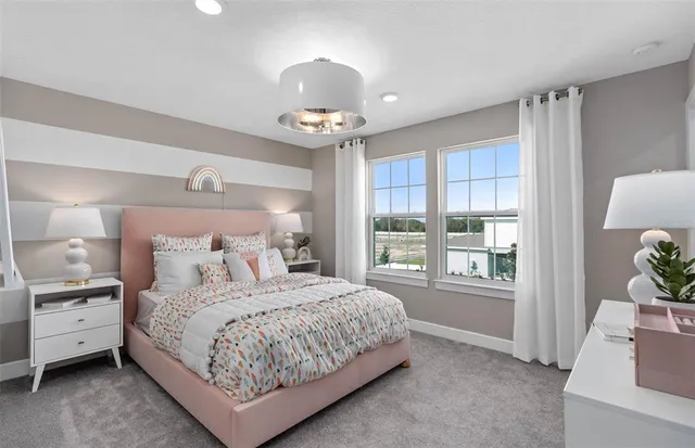 a bedroom with a large bed and a chandelier