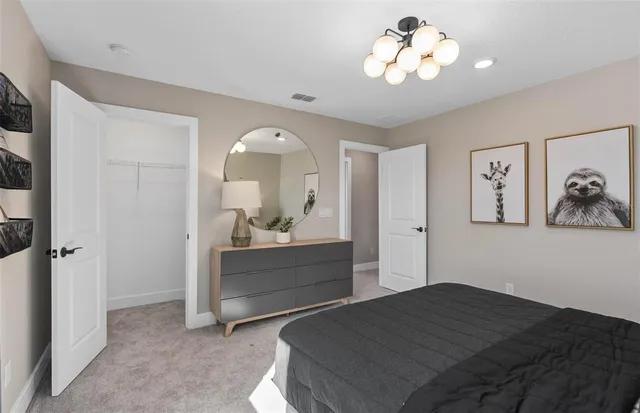 a bedroom with a bed and a chandelier