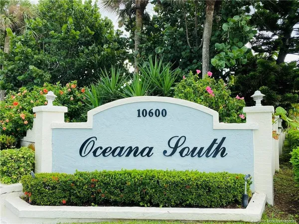 a sign broad in front of the tree
