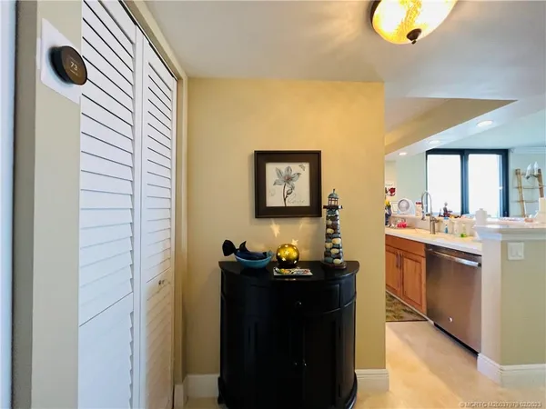 a kitchen with kitchen island granite countertop a sink counter top space appliances and cabinets