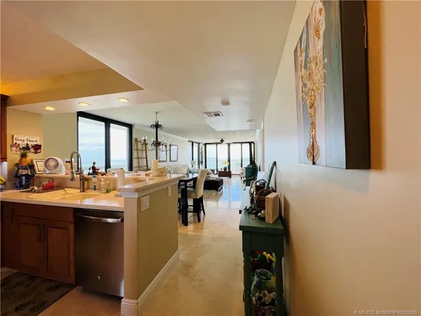a kitchen with stainless steel appliances granite countertop a refrigerator a sink and a stove