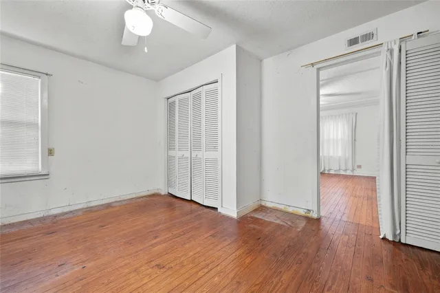 a view of a room with wooden floor and window