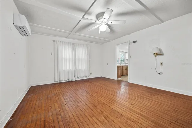 wooden floor in an empty room with a window