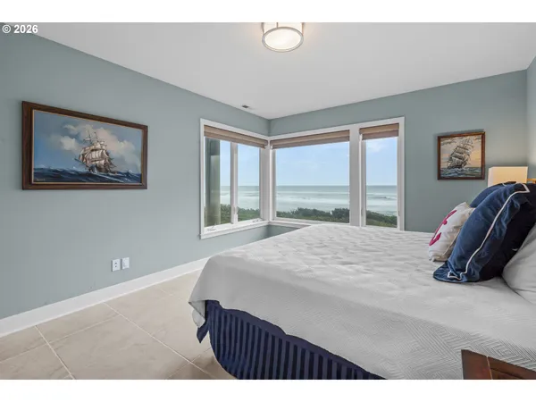 a bedroom with a bed and painting on the wall