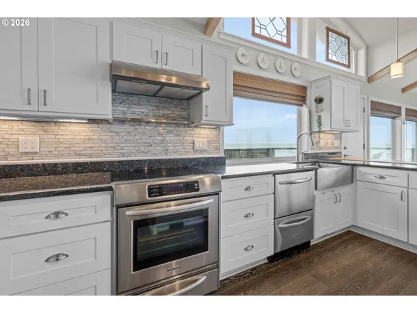 a kitchen with a sink stove and cabinets