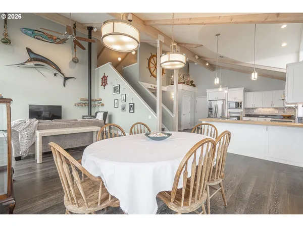 a kitchen with stainless steel appliances kitchen island granite countertop a refrigerator and a sink